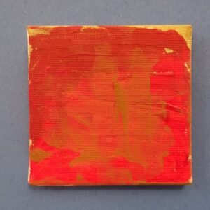Small square canvas with abstract red and orange painting.