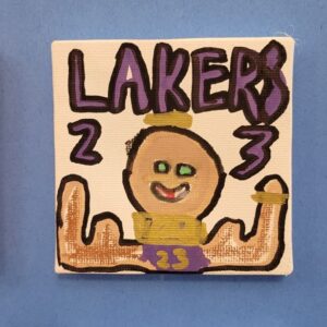 A cartoon figure wearing a crown and Lakers jersey with the number 23, with the word "LAKERS" above.