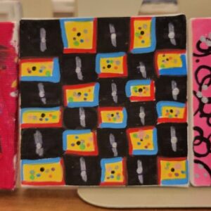 Square canvas with colorful grid pattern featuring red, blue, yellow, and black rectangles with dot designs.