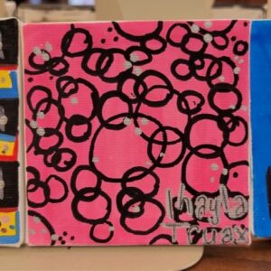 Pink background with overlapping black circles and silver dots