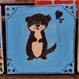 Painting of a cartoon otter on a blue background with decorative stars and a heart with a "J".