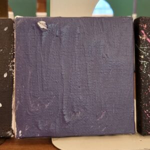 Small canvas with textured purple paint.