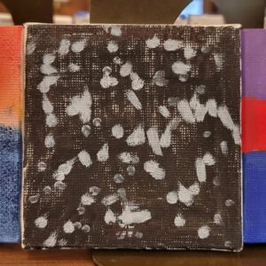 Abstract painting with silver brushstrokes on a black canvas.