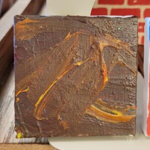 Small canvas with brown, orange, and yellow abstract brushstrokes.