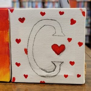 Canvas with a black outlined "C" and red hearts.