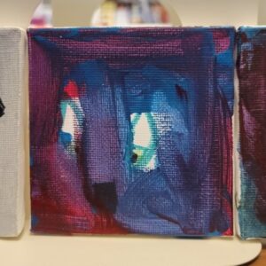 Abstract painting with blue, purple, and red hues featuring eye-like shapes in the center.