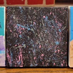 Abstract painting with pink, blue, and gray splatters on a black background.