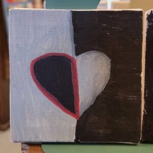 Abstract painting of a heart on a divided gray and black background.