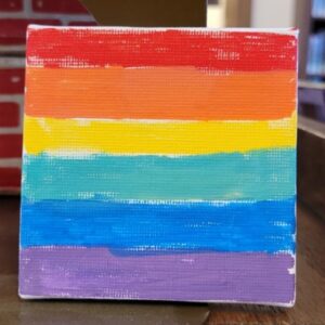 Small canvas with horizontal rainbow stripes in red, orange, yellow, green, blue, and purple.