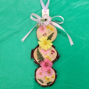 Decorative ornament with dried flowers on three wooden slices