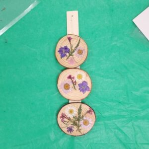 Three wood slices with pressed flowers