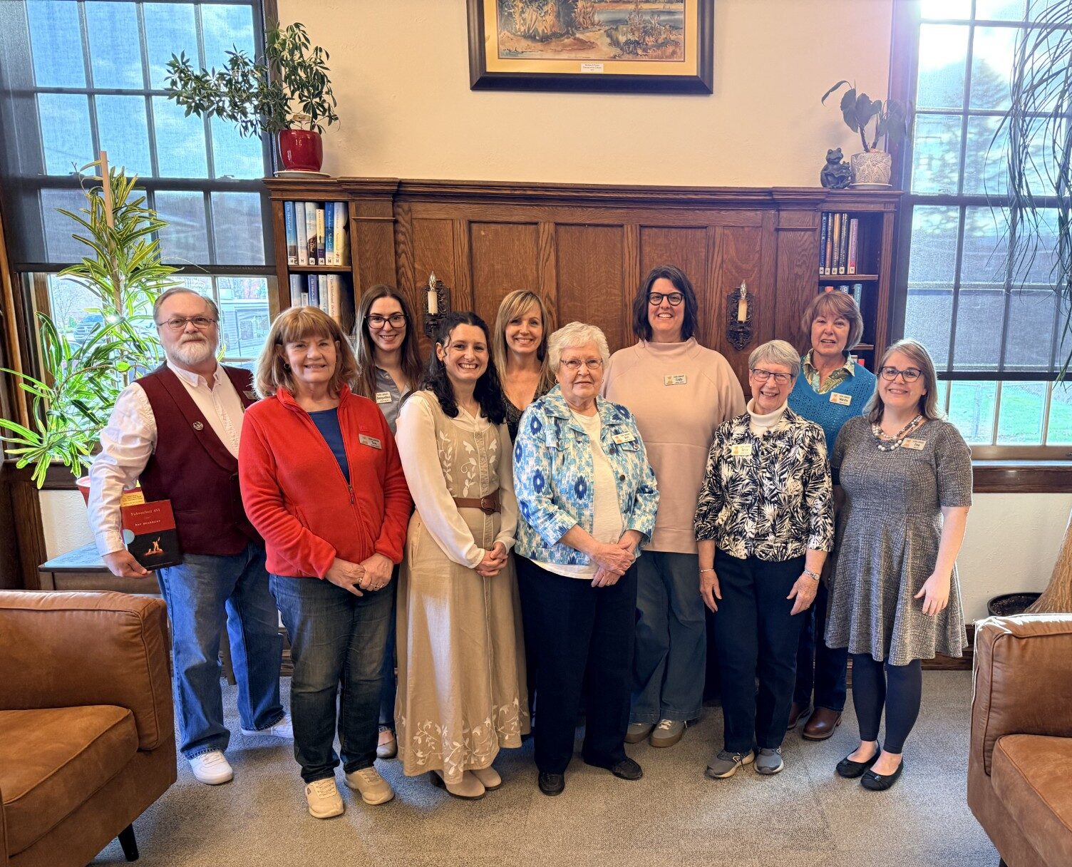 image of ten people in a library setting